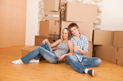 Movers loading boxes at a Knightsbridge apartment entrance