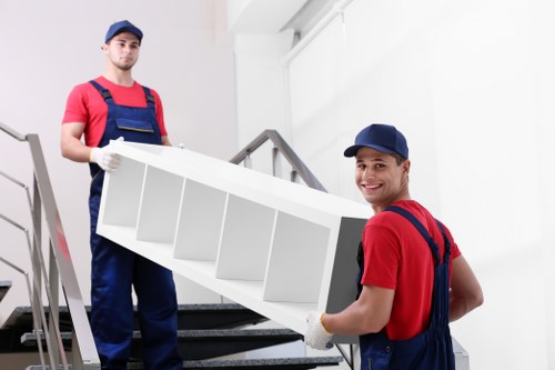 Professional team securing a grand piano for safe loading