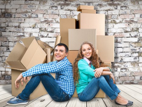 Moving van and removal team preparing household items for collection
