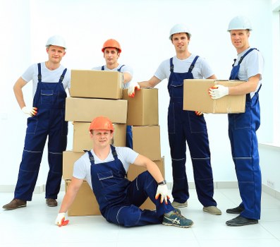 Professional movers loading furniture into a moving truck in Knightsbridge