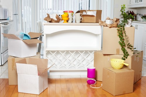 Removal professionals handling packed boxes during a scheduled move