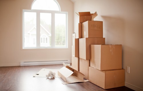 Professional removals team working safely with packed boxes