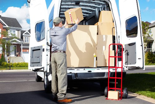 Professional movers loading furniture into a Knightsbridge removal van